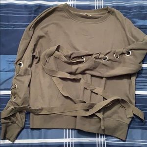 Grean sweater with designs on arms